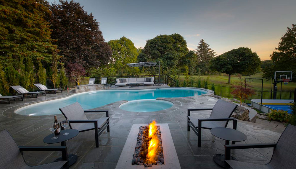 swimming pool in backyard with fire pit