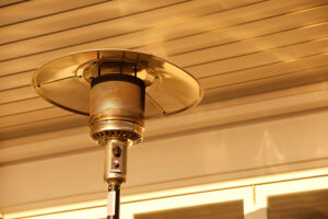 Close-up of an outdoor heater on a covered terrace.